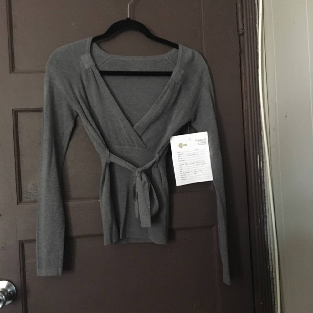 Gray wrap around style sweater, with front tie.